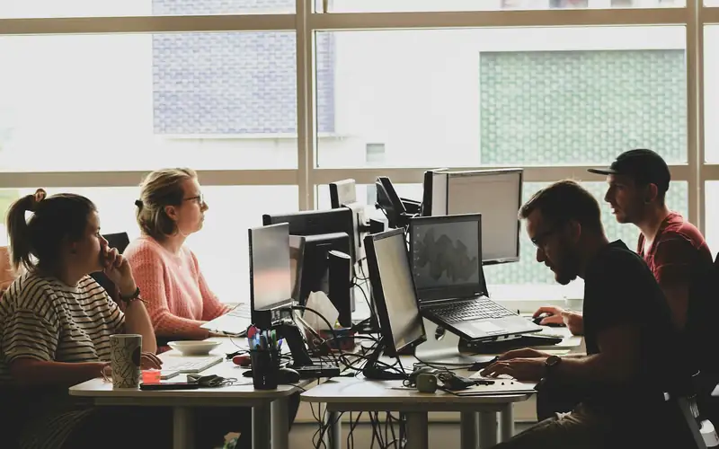 Engineers working at their desks in a bright, open-plan office